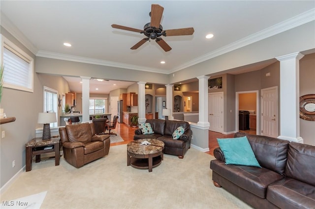 living area featuring ornamental molding, light carpet, decorative columns, and baseboards