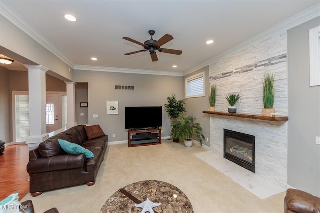 living area featuring recessed lighting, visible vents, baseboards, ornamental molding, and ornate columns