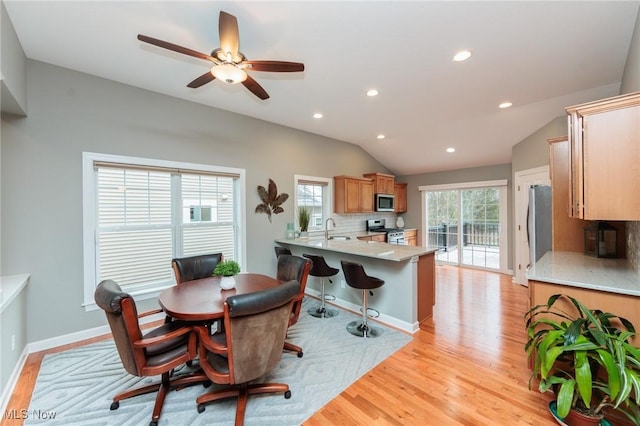 dining space featuring recessed lighting, ceiling fan, vaulted ceiling, light wood-type flooring, and baseboards