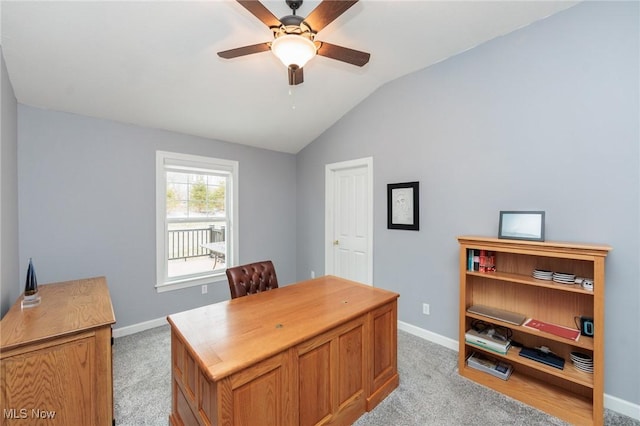 home office featuring ceiling fan, baseboards, vaulted ceiling, and light colored carpet