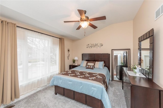 bedroom with a ceiling fan, visible vents, vaulted ceiling, and carpet flooring