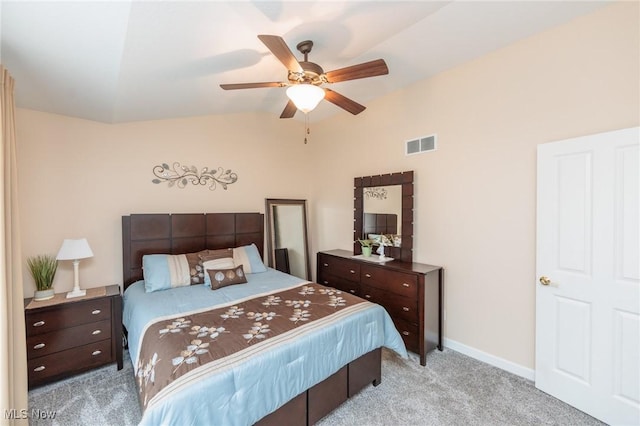 bedroom featuring ceiling fan, light carpet, visible vents, baseboards, and vaulted ceiling