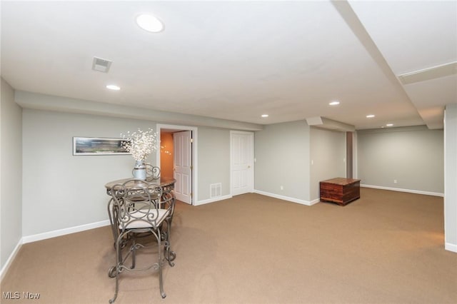 finished below grade area with baseboards, carpet, and recessed lighting