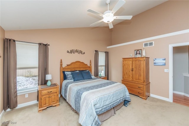 bedroom featuring lofted ceiling, baseboards, visible vents, and light colored carpet