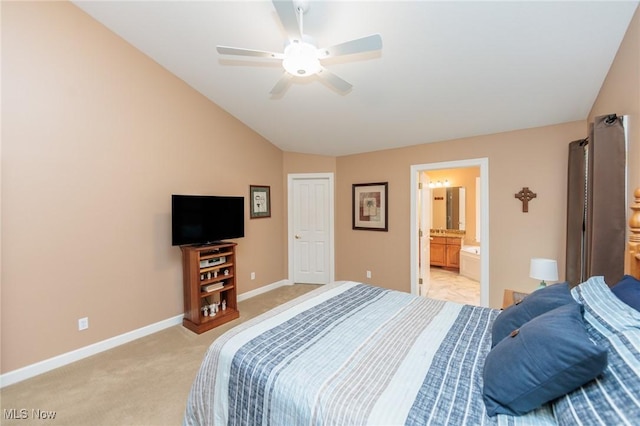 bedroom featuring light carpet, baseboards, lofted ceiling, ceiling fan, and ensuite bathroom