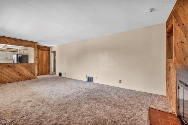 unfurnished living room featuring carpet