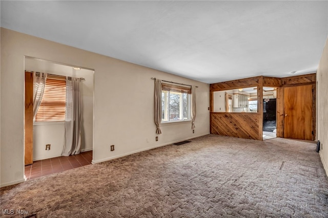 unfurnished living room featuring carpet floors and visible vents