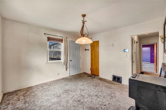 unfurnished dining area with carpet floors, baseboards, and visible vents