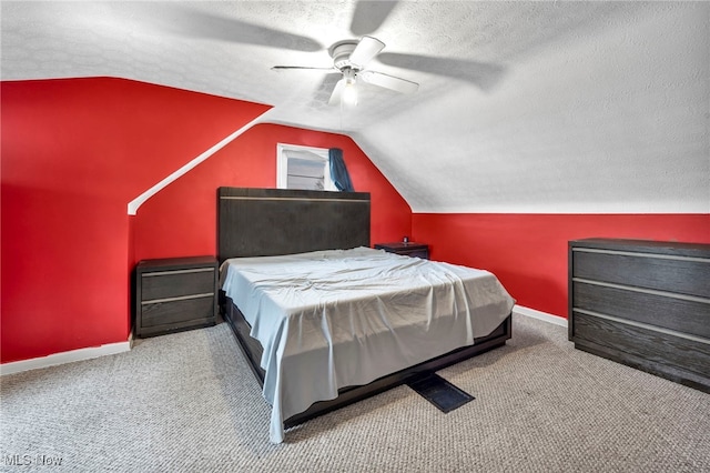 bedroom featuring lofted ceiling, baseboards, and a textured ceiling