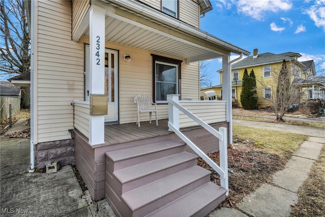 view of exterior entry featuring a porch