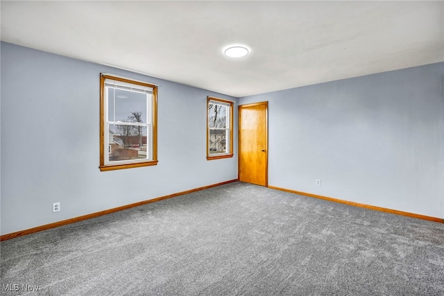 spare room with carpet flooring and baseboards