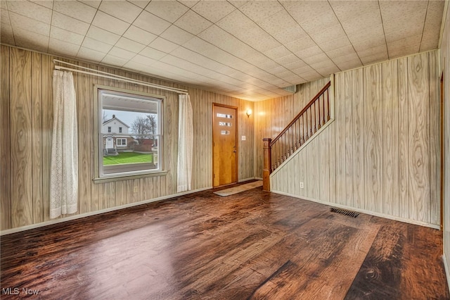 entryway featuring stairs, wood finished floors, visible vents, and baseboards