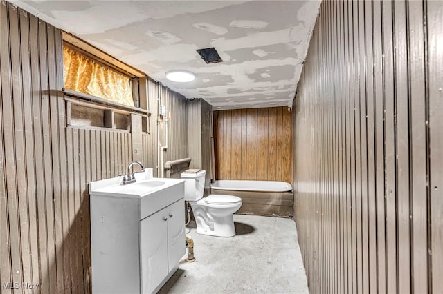 full bathroom with a tub to relax in, unfinished concrete flooring, toilet, wooden walls, and vanity