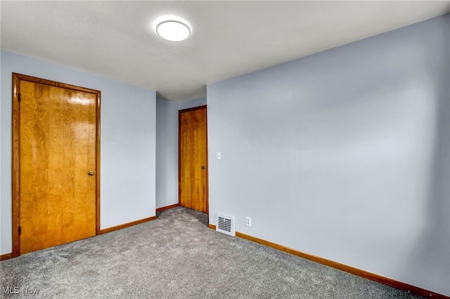 unfurnished bedroom featuring carpet floors, visible vents, and baseboards