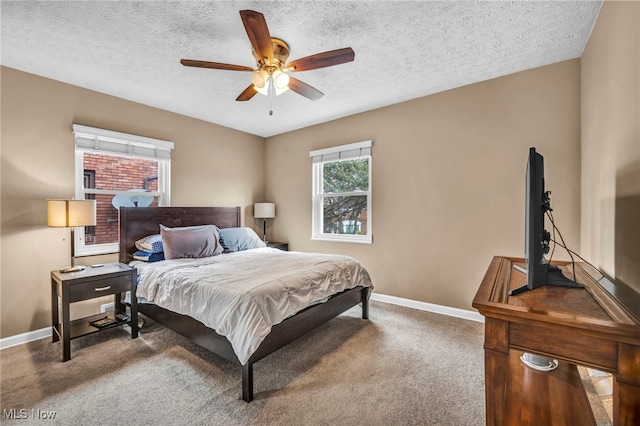 bedroom featuring ceiling fan, a textured ceiling, baseboards, and carpet flooring