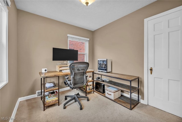 home office with carpet, baseboards, and a textured ceiling