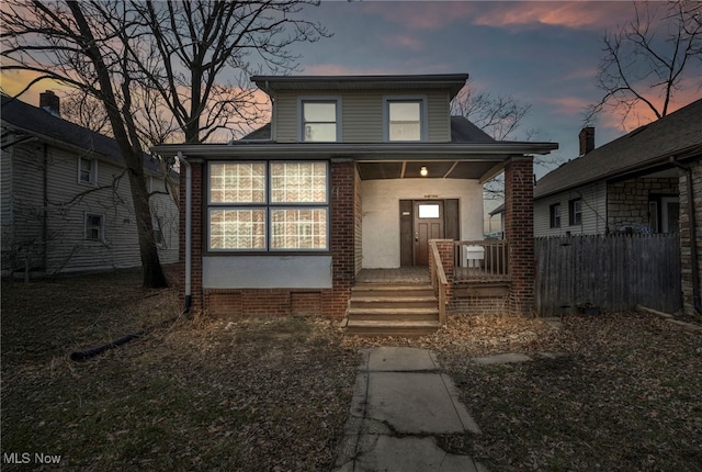 view of front of home with covered porch and stucco siding