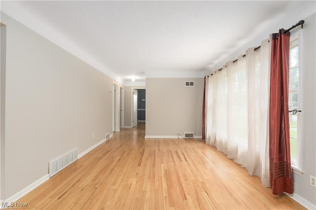 spare room featuring visible vents and light wood-style flooring