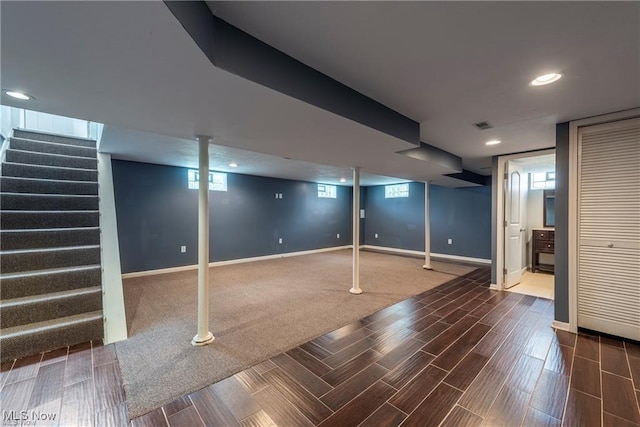 basement featuring wood finish floors, recessed lighting, visible vents, stairway, and baseboards