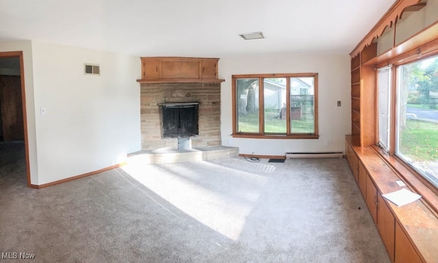 unfurnished living room featuring carpet floors, visible vents, a baseboard heating unit, a stone fireplace, and baseboards