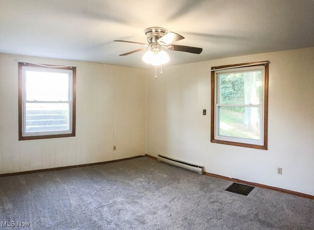 carpeted spare room with a ceiling fan, a baseboard radiator, and baseboards