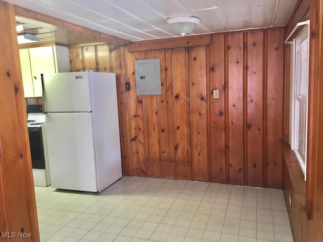 kitchen with freestanding refrigerator, electric panel, wooden walls, and electric range oven