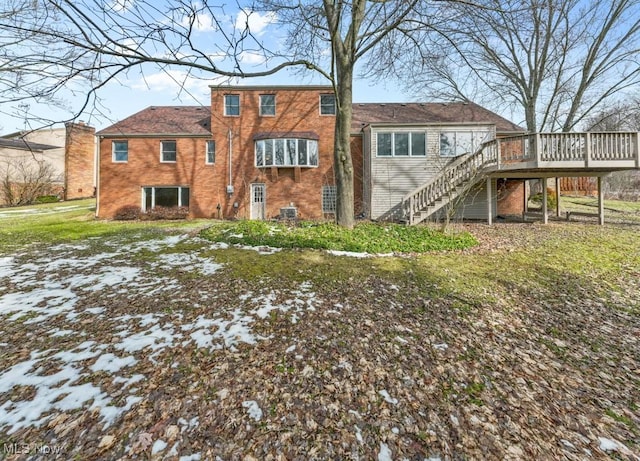 back of house featuring brick siding, a deck, and stairs