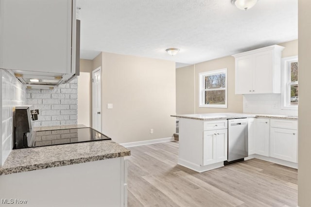 kitchen with a peninsula, stove, white cabinetry, decorative backsplash, and dishwasher