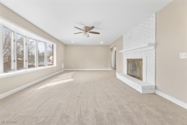 unfurnished living room with baseboards, ceiling fan, carpet, a brick fireplace, and recessed lighting