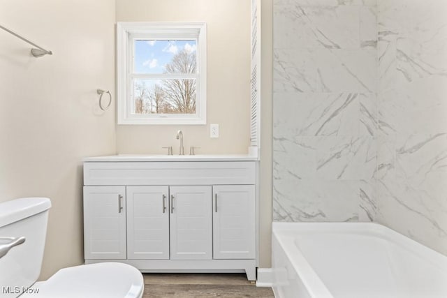 full bathroom featuring vanity, toilet, and wood finished floors