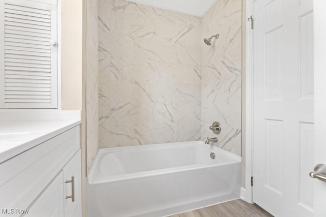 bathroom featuring vanity, shower / tub combination, and wood finished floors