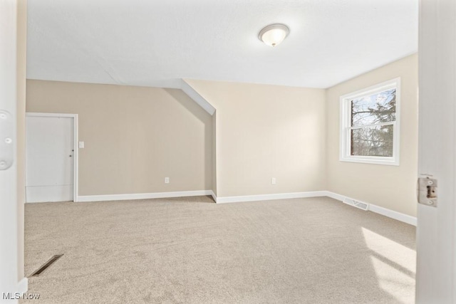 additional living space with carpet flooring, visible vents, and baseboards