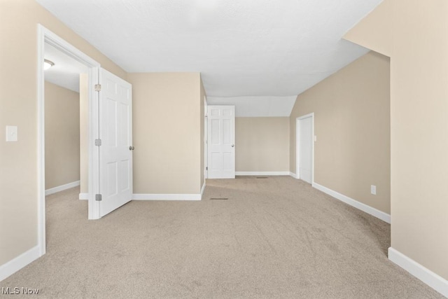 carpeted spare room featuring baseboards