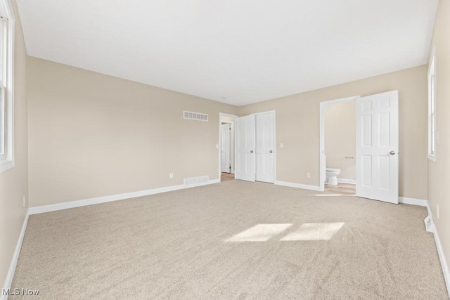 unfurnished bedroom with baseboards, visible vents, and carpet flooring