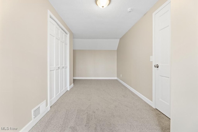 bonus room with carpet flooring, visible vents, and baseboards