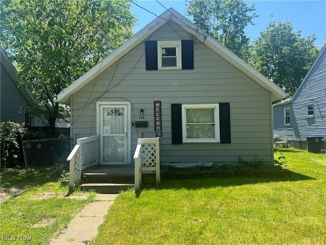 bungalow-style home featuring a front yard