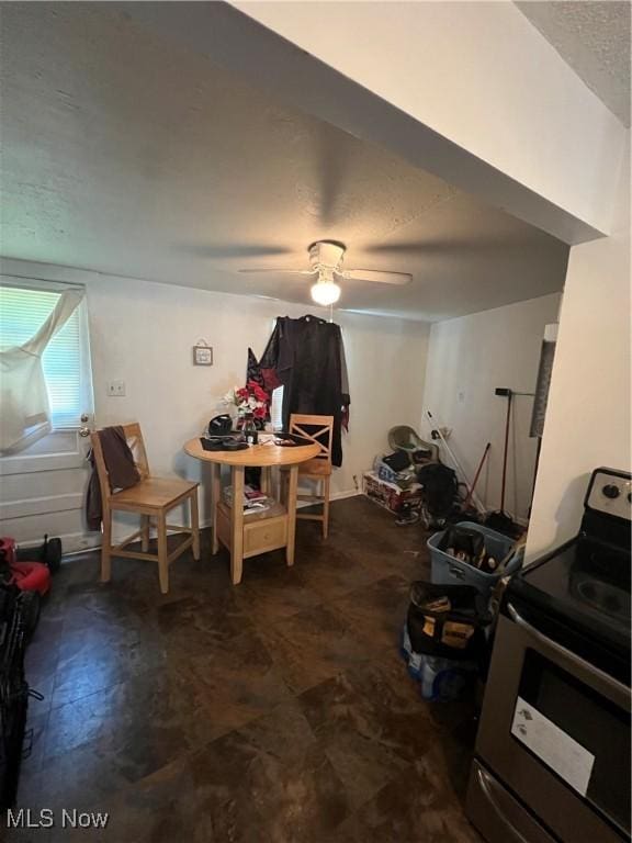 dining area featuring ceiling fan and a textured ceiling