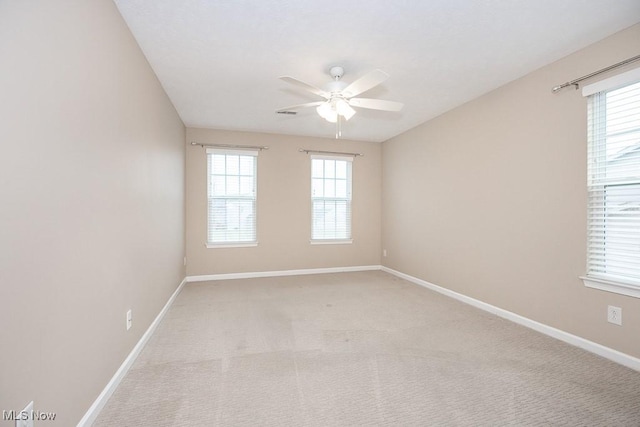 empty room with plenty of natural light and baseboards