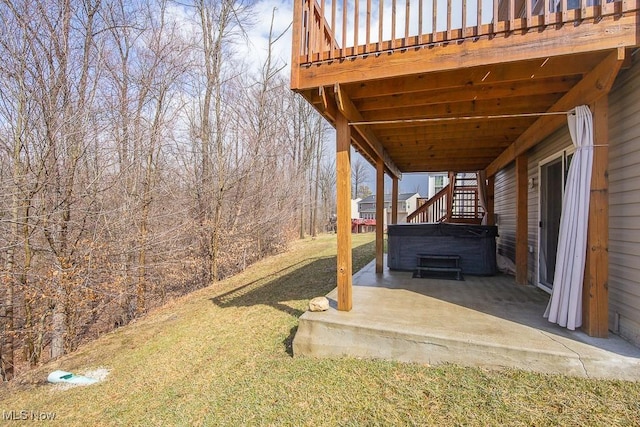 view of yard with a patio, stairway, and a hot tub