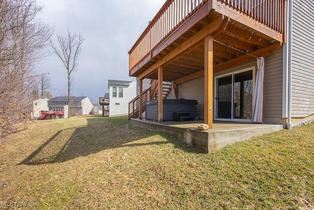 view of yard with stairway, a hot tub, and a patio