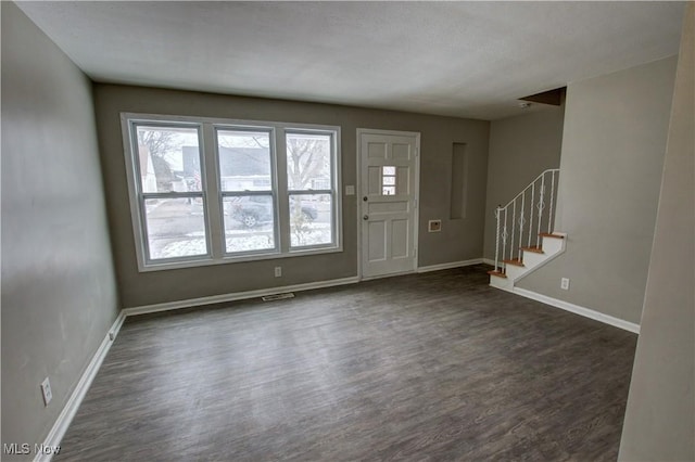 entryway featuring dark wood-style floors, visible vents, stairway, and baseboards