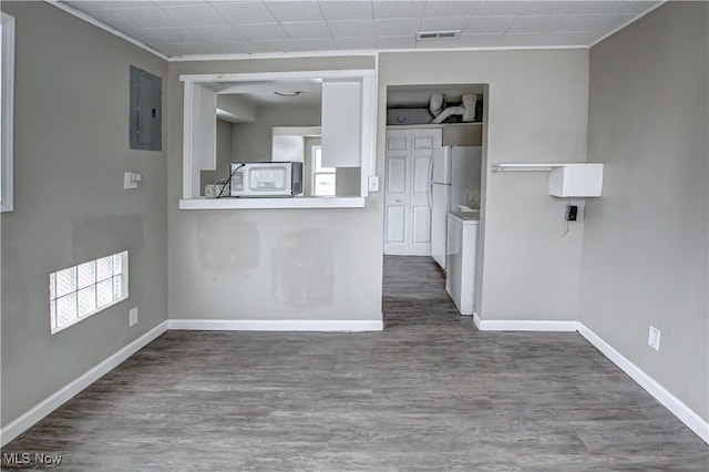 kitchen with electric panel, baseboards, visible vents, dark wood-style flooring, and freestanding refrigerator