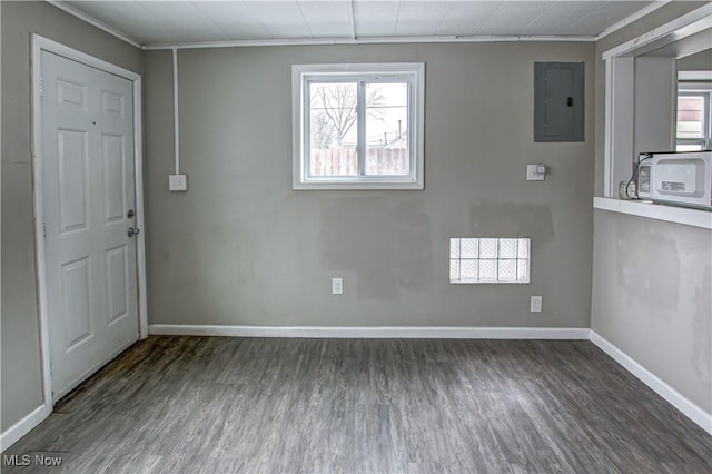 foyer entrance featuring ornamental molding, electric panel, baseboards, and wood finished floors