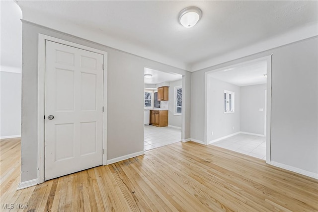 spare room featuring light wood-style flooring and baseboards