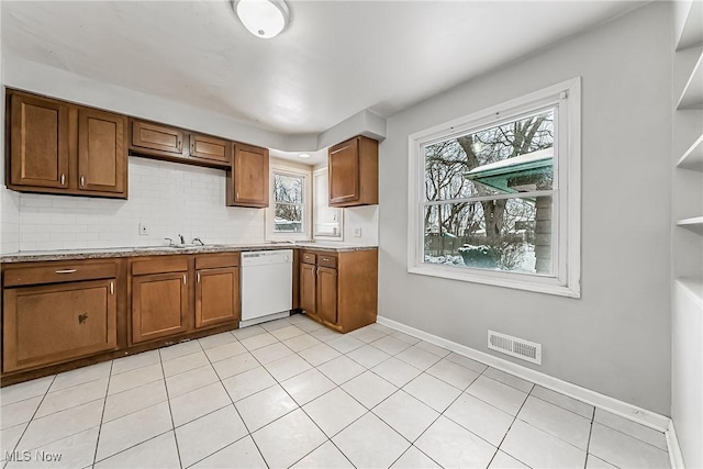 kitchen with open shelves, white dishwasher, visible vents, and brown cabinets