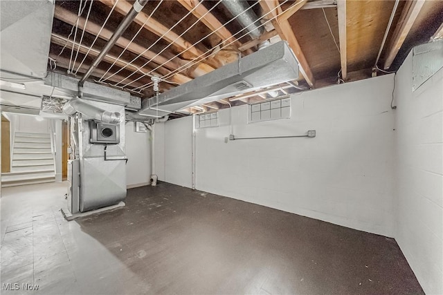 unfinished basement featuring heating unit