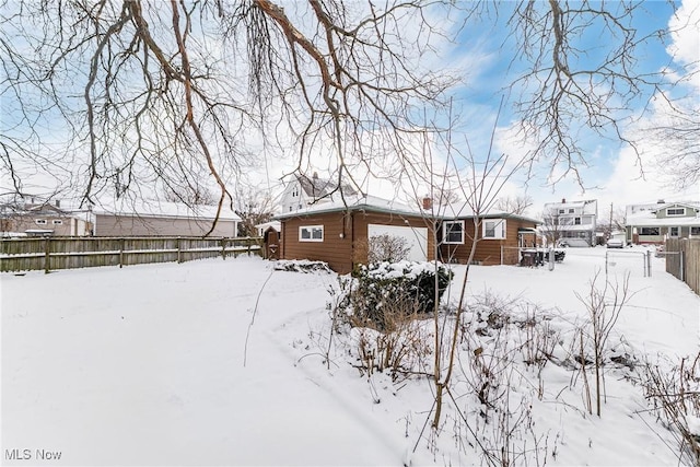 exterior space with a garage and fence