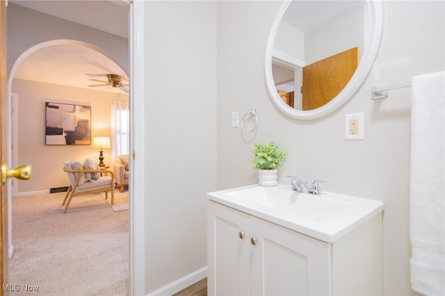 bathroom featuring ceiling fan, visible vents, vanity, and baseboards