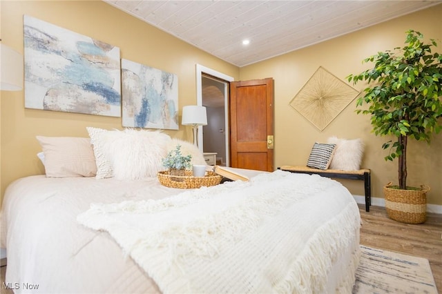 bedroom featuring recessed lighting, wooden ceiling, baseboards, and wood finished floors