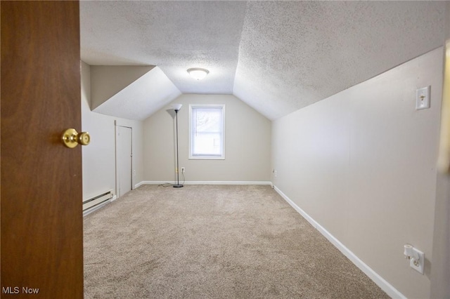 bonus room with baseboards, carpet, vaulted ceiling, baseboard heating, and a textured ceiling